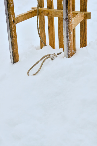 A Wooden sled stuck in a snowbank