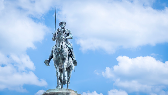 Chantilly, France – May 18, 2023: The equestrian statue of Constable Anne de Montmorency under a cloudy blue sky