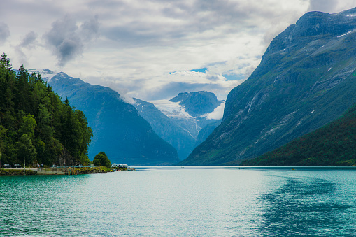 Scenic view of turquoise coloured glacial lake Lovatnet surrounded by Jested glacier and beautifull summer mountain peaks in Western Norway, Scandinavia