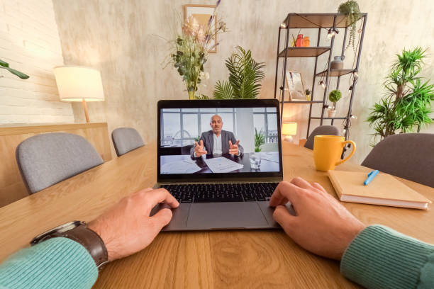 istock Young Man Having A Video Conference While Working At The Kitchen Table At Home 2062962593