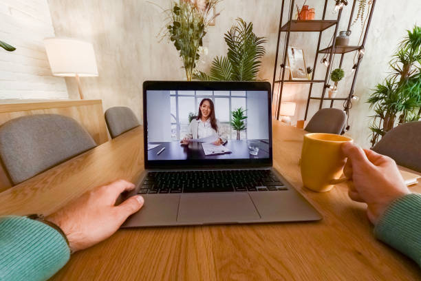 istock Young Man Having A Video Conference While Working At The Kitchen Table At Home 2062971667