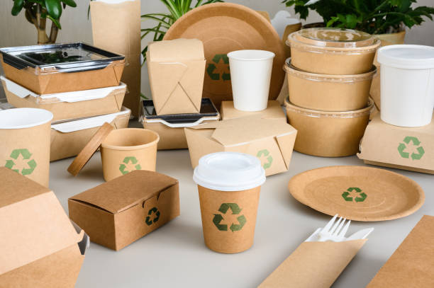 istock Disposable paper tableware with recycling signs stands on the table. Zero waste and recycling concept 2062974872