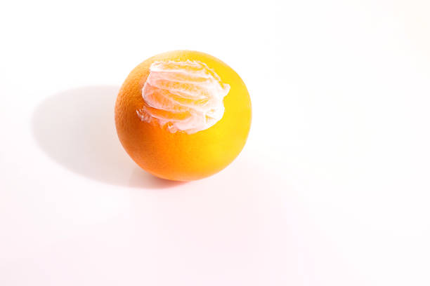 Anticellulite concept, anti cellulite cream on orange fruit, copy space