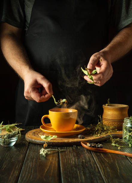 istock Making healthy green tea from medicinal herbs. Adding dry linden to boiling water to relieve a cold or high fever. Treatment of influenza virus 2062995202