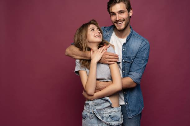 istock Happy loving couple isolated isolated on red background. 2063020833