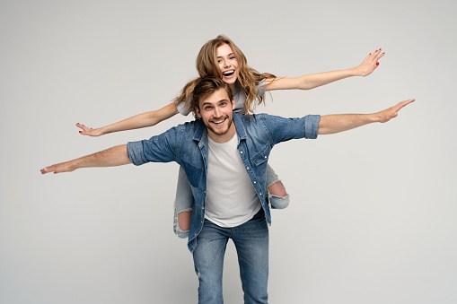 Photo pretty lady handsome guy couple carry piggyback meet adventures playful mood in love forever wear casual denim shirts outfit isolated on white background