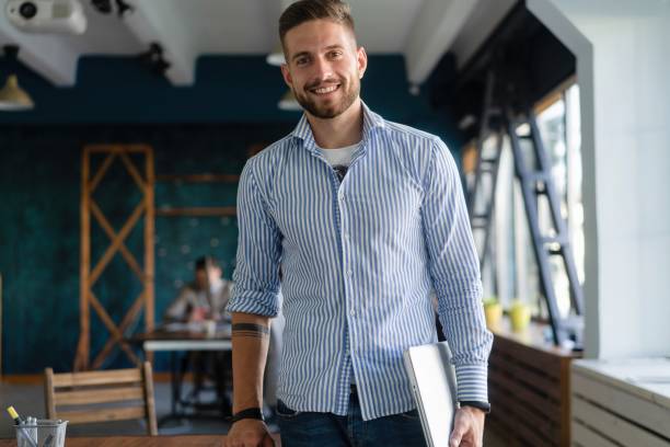 istock Portrait Of Man Standing In Busy Creative Office. 2063033774