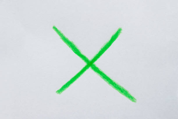 Hand drawn green x sign on white paper. Clipping path.