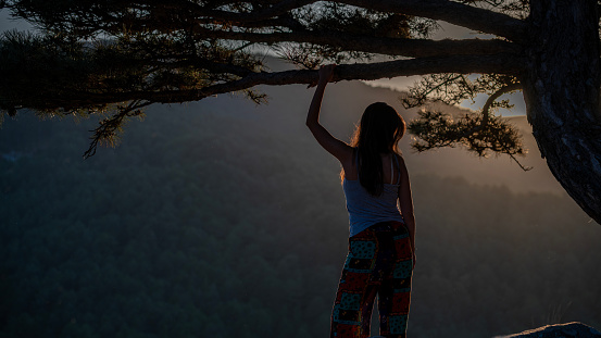 Young woman hiking in the Kazdağı (Mount Ida) National Forest park, arms outstretched for freedom and positive emotion.