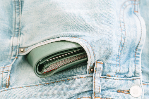 A wallet inside a jeans pocket