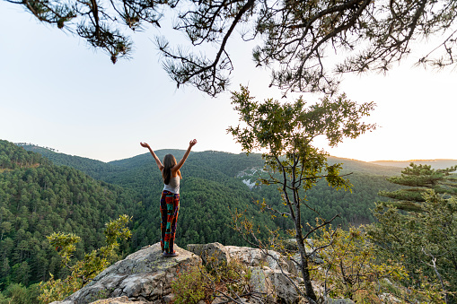 Young woman hiking in the Kazdağı (Mount Ida) National Forest park, arms outstretched for freedom and positive emotion.