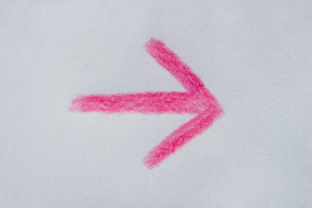 Hand drawn pink arrow on white paper. Clipping path.