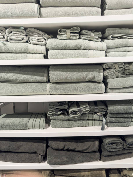 istock Light colored towels are stacked on shelves in a store 2063088522