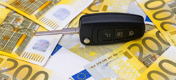 Car keys on paper Euro money for buying and renting. Sale concept