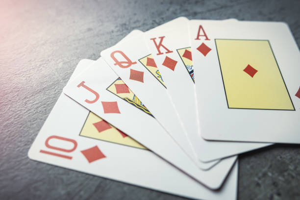Diamonds royal flush playing cards poker combination on grey background. Tension risk game