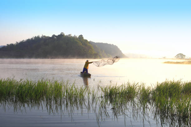 Local fishermen use a fishnet to capture fish in the lake