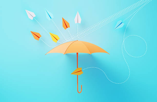 istock Colorful Umbrella Establishing A Shield Against Paper Planes Coming At Different Directions On Blue Background 2063090714