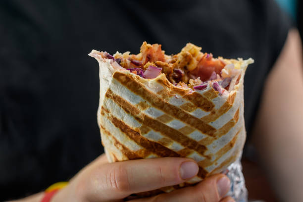 istock Kebab rolled into a tortilla, grilled and held in hand 2063093125