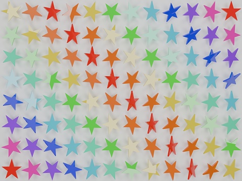 Three-dimensionally (3D) designed colored plastic stars in front of a white background