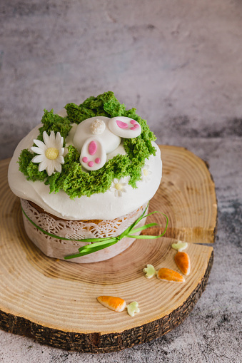 Easter Cakes decorated with a hare dives into a hole on wooden plate - Traditional Kulich, Paska Easter Bread. Traditional Easter spring