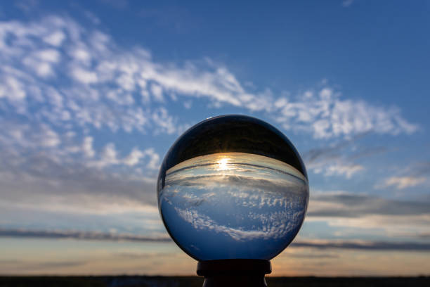 Beautiful sunset reflected in a crystal ball. Bright sunset with colorful clouds over the horizon in the evening reflected in the crystal ball. Moscow, Russia.