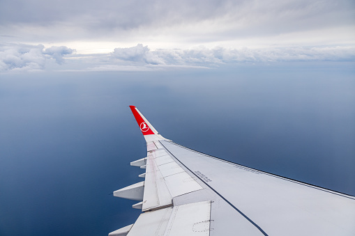 Airspace above the Baltic Ocean - January 3th 2024:  Wing and winglet of an Airbus 320 from Turkish Airlines taking a turn while climbing out of Copenhagen Airport