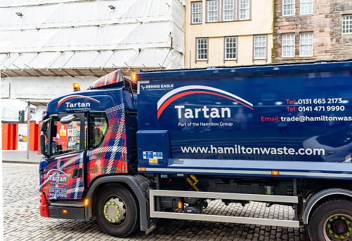 Royal Mile, Edinburgh, Scotland, August 2023. This is the Royal Mile early morning during the Edinburgh Fringe Festival.  There is a waste disposal lorry in the foreground.