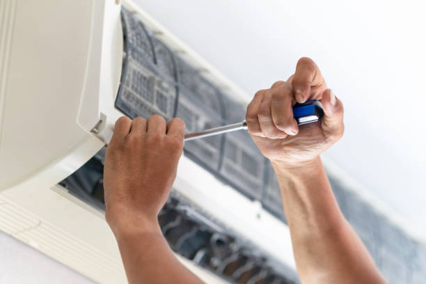 istock Hands of technician using screwdriver to fix air conditioning system, Repairman service for repair and maintenance of air conditioners 2063136247