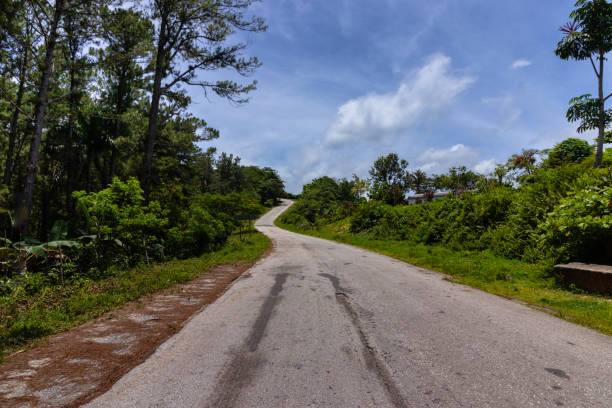 istock Mountain road at noon in the bright sun 2063138432