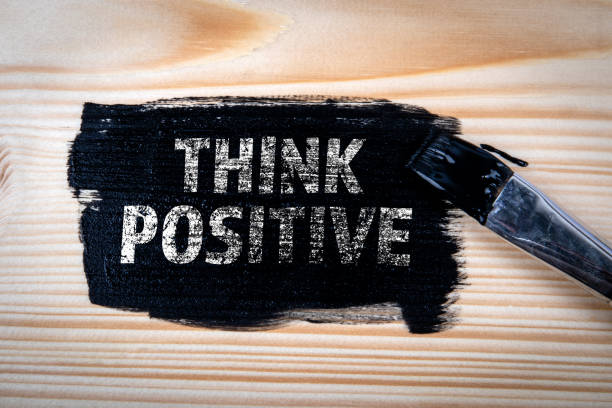 istock Think Positive Concept. Black paint and brush on wood texture background 2063148439