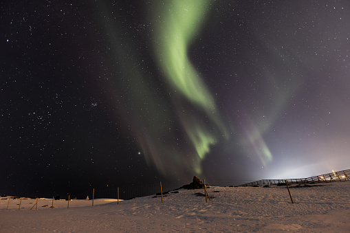 Beautiful northern lights (aurora borealis) on clear sky.\nNorthern Norway  - Hammerfest.