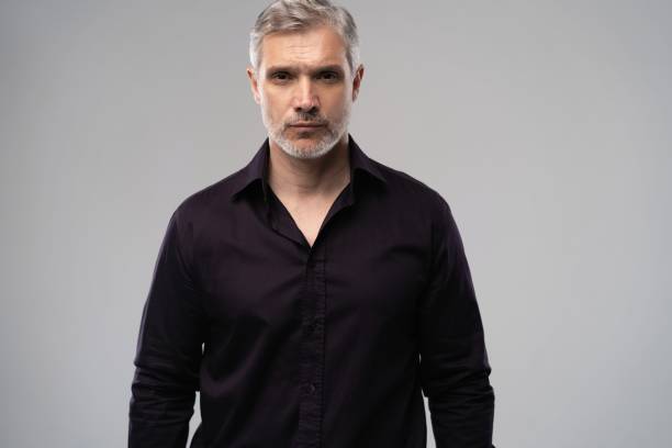 istock Handsome man posing in black shirt on white background in studio 2063168422