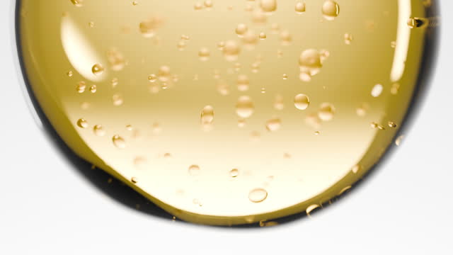 Close-up yellow realistic liquid and bubble