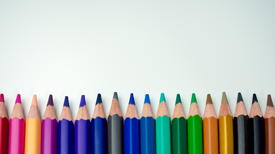 Set of colored pencils on a white background That is arranged in a bar graph, Color pencils on white background, Close up, seamless colored pencils row with wave on lower side, line pencils.