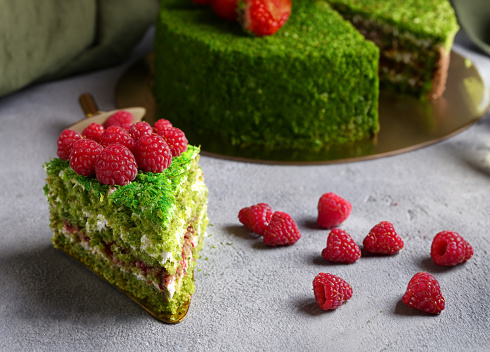 pistachio cake with fresh raspberries and buttercream