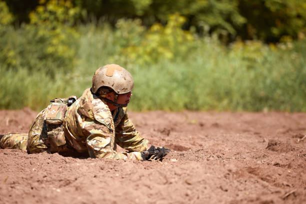 istock Soldiers game on military training ground battle camp. Action. Operation Trainer giving training to military soldiers at boot camp 2063211883