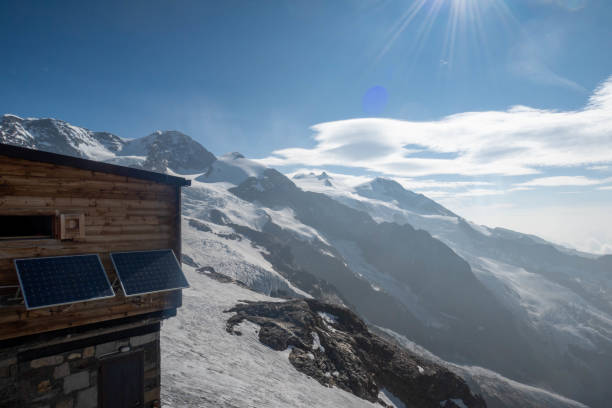 Amidst the unexpected beauty of summer, a snowy alpine landscape unfolds high atop mountain summits. Nature's contrasting elements create a serene panorama, where lush greenery meets lingering snow, crafting a picturesque scene in the heart of the Swiss mountains.
