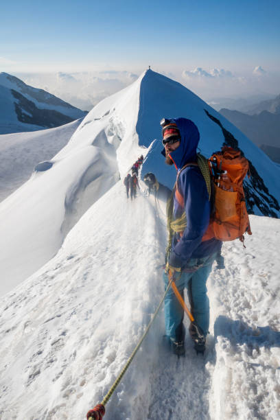 istock Alpinist aiming for the summit on snowy ridge 2063221917