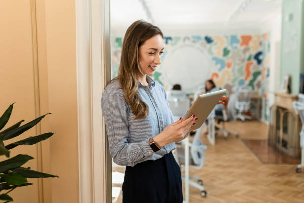 istock Young businesswoman in an office using digital tablet 2063222432