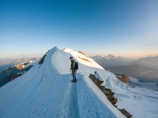 istock Alpinist aiming for the summit on snowy ridge 2063222966