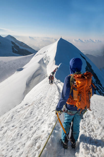 istock Alpinist aiming for the summit on snowy ridge 2063222969
