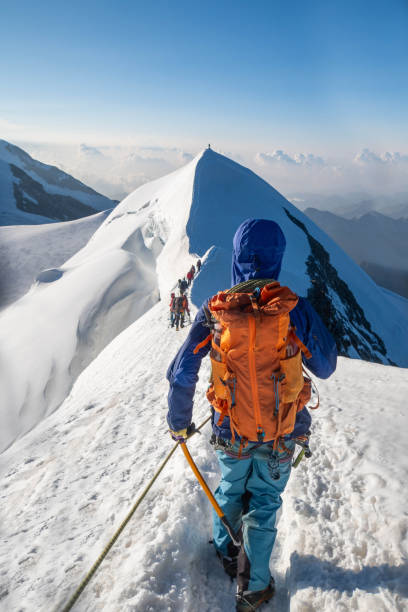 istock Snowy Summit Pursuit: Alpinist's Ascent along the Icy Ridge