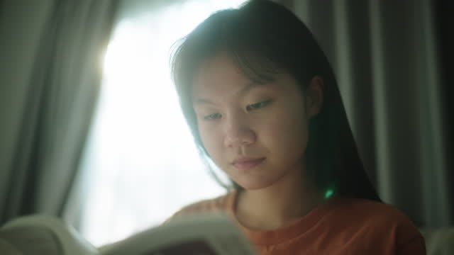 Teenage girl reading a book.