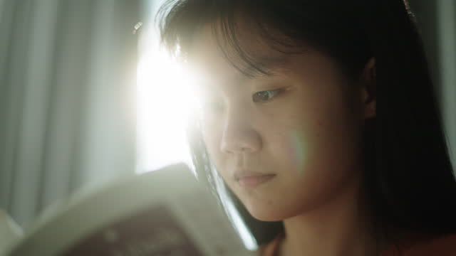 Teenage girl reading a book.