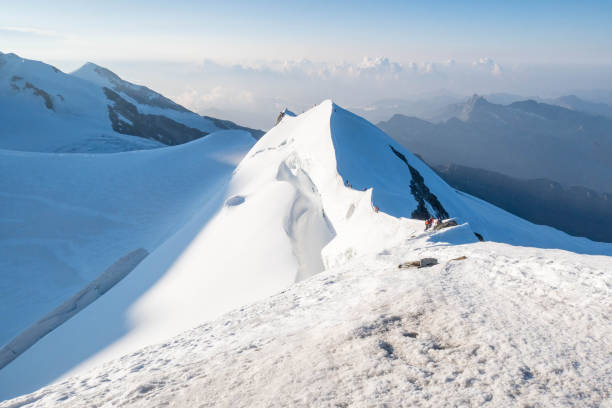 Amidst the unexpected beauty of summer, a snowy alpine landscape unfolds high atop mountain summits. Nature's contrasting elements create a serene panorama, where lush greenery meets lingering snow, crafting a picturesque scene in the heart of the Swiss mountains.
