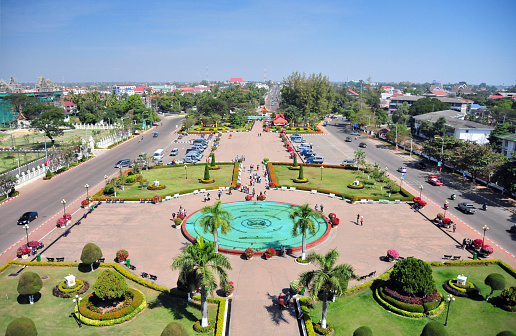 Vientiane, Laos: garden with musical fountain of Patuxai square seen from above - looking NE along Kaysone Phomvihane Avenue