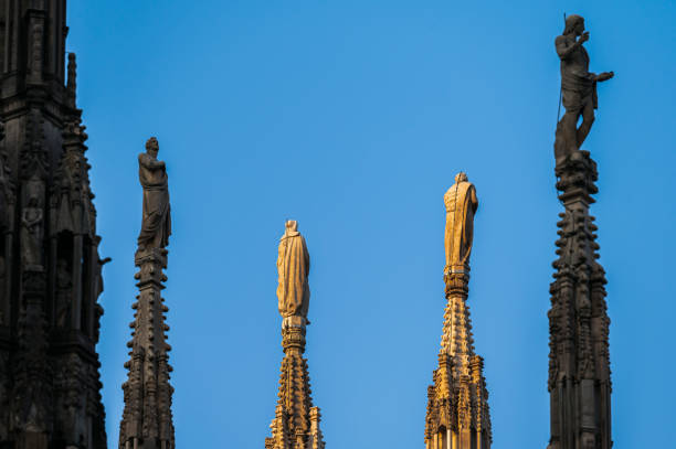 Beautiful architectural details with statues on the top of building of the Milan Cathedral (Duomo di Milano), the cathedral church of Milan, Lombardy, Italy. Dedicated to the Nativity of St Mary.