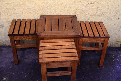 wooden tables and stools in the street