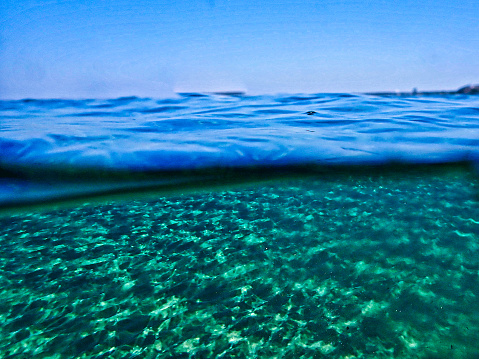 Over/under shot of East Grand Traverse Bay of Lake Michigan at Traverse City, during the Winter.