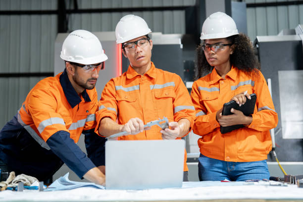 istock Multiracial engineer team collaborates in a factory brainstorm, uniting diverse skills for innovative solutions. 2063249448
